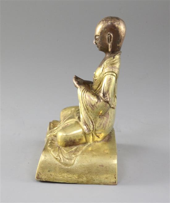 A Chinese gilt copper seated figure of a luohan, probably Qing dynasty, height 15cm